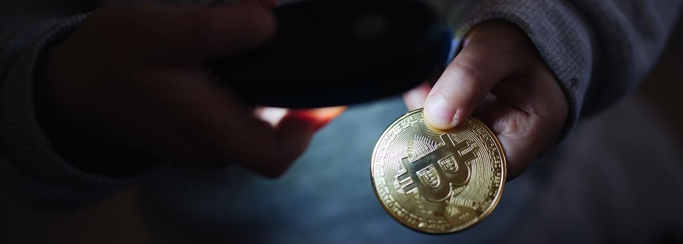 Physical bitcoin tokens arranged on a dark surface