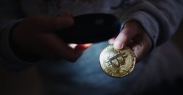 Physical bitcoin tokens arranged on a dark surface