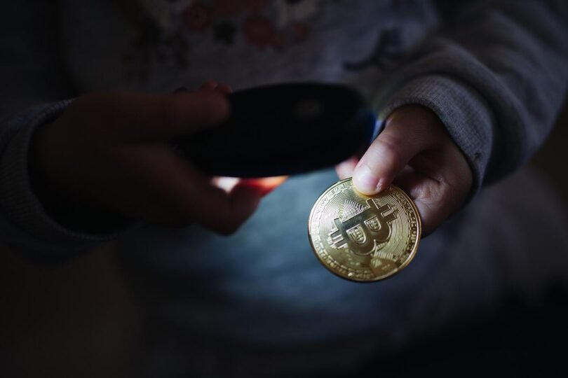 Physical bitcoin tokens arranged on a dark surface