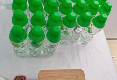 Rows of green plastic bottled water on a shop shelf