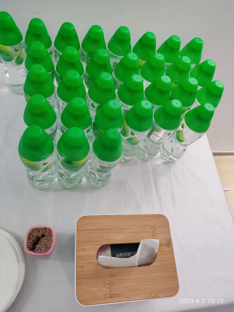 Rows of green plastic bottled water on a shop shelf