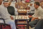 Two men playing a board game at a table