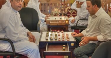 Two men playing a board game at a table
